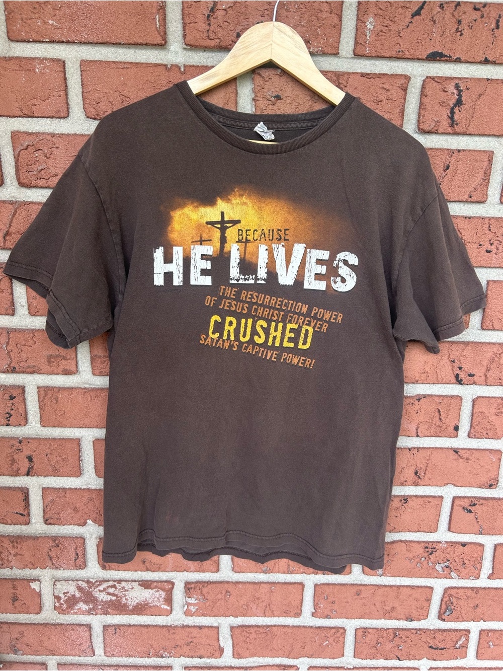 Delta Brown 'He Lives' Graphic Short Sleeve Tee with Yellow-Orange Accent